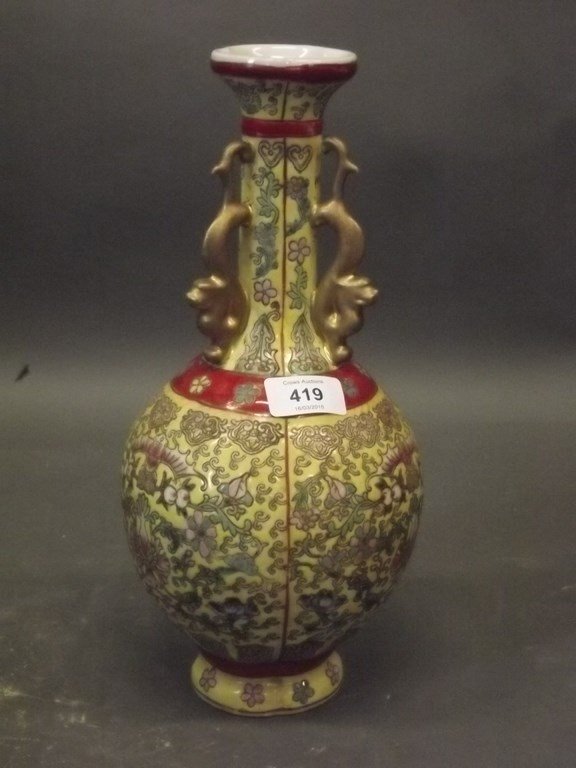 A Chinese porcelain vase with ribbed body and enamel: A Chinese porcelain vase with ribbed body and enamel decoration of peach, bat and lotus, with three gilt dragon handles, seal mark to base, 12Â½" high