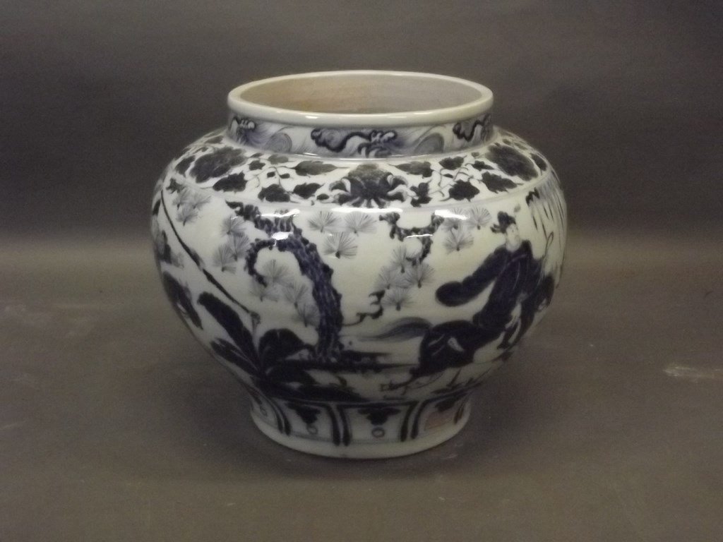 A Chinese earthenware jardiniÃ¨re with blue and white: A Chinese earthenware jardiniÃ¨re with blue and white decoration of three horsemen, signed to body and base, 11" high