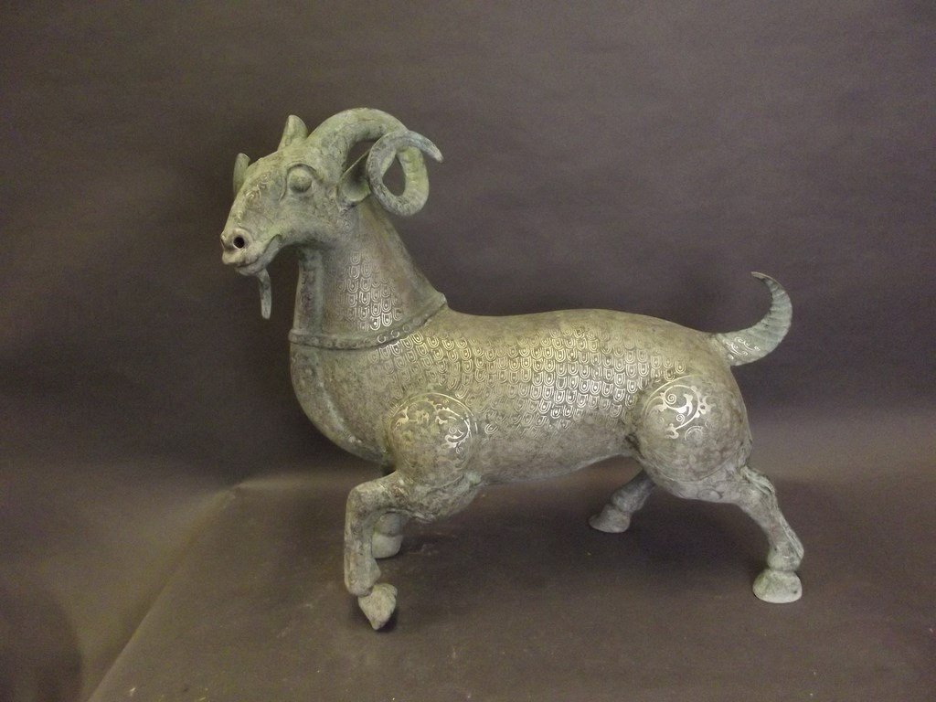A Middle Eastern metal figure of a ram with intricate (1 of 3)