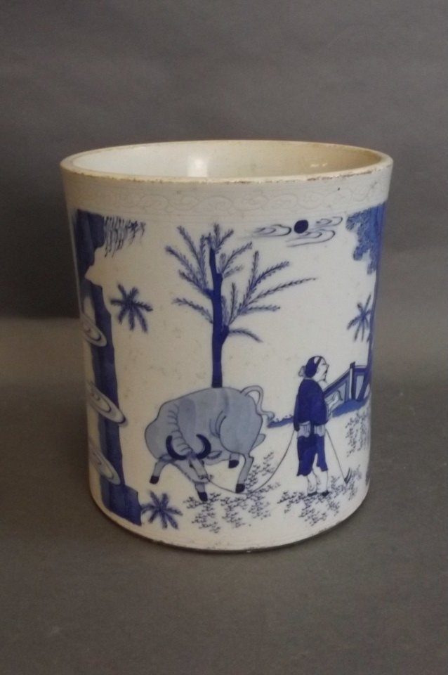 A Chinese blue and white brushpot with flared rim and: A Chinese blue and white brushpot with flared rim and painted decoration of a farmer and his ox, 6" high
