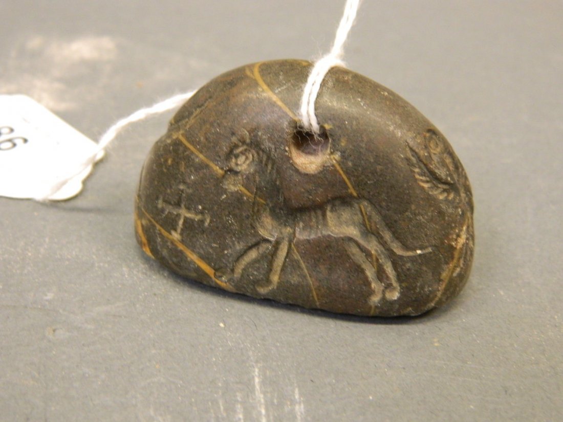 A Middle Eastern stone seal with carved sphinx, horse (1 of 4)