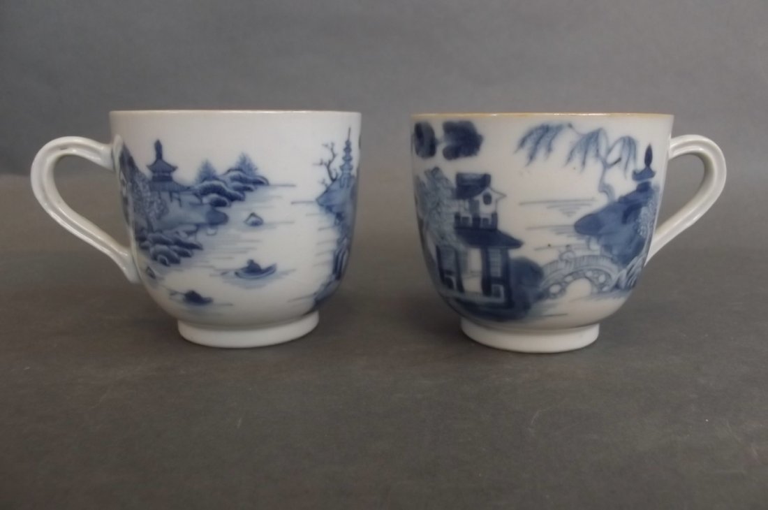 A C19th Chinese blue and white porcelain tea cup: A C19th Chinese blue and white porcelain tea cup decorated with pagodas by a river and figures in boats, and another similar, 2" high