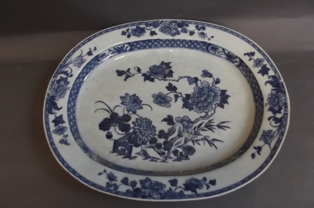 A C19th Chinese blue and white oval serving platter: A C19th Chinese blue and white oval serving platter decorated with chrysanthemums within a lattice border, 15" x 12"