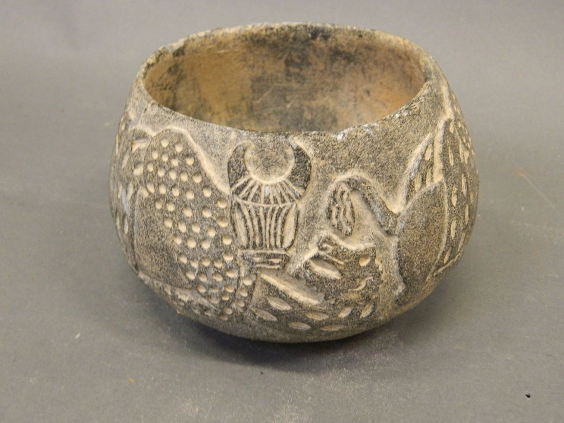 An Eastern stone bowl with carved decoration of bulls: An Eastern stone bowl with carved decoration of bulls and dragons, 6" x 4"