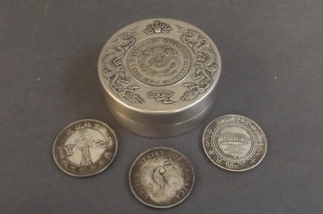 A Chinese white metal coin pot with relief dragon (1 of 3)