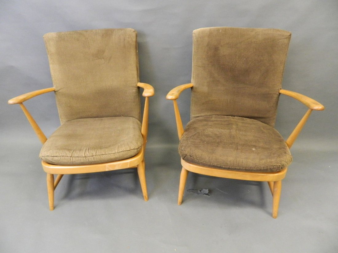 A pair of Ercol cottage armchairs with upholstered: A pair of Ercol cottage armchairs with upholstered backs, 32" high, seats 20" wide
