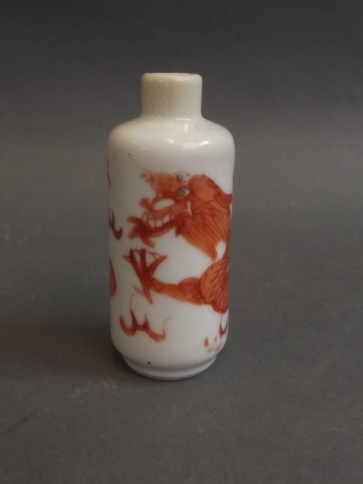 A late C19th Chinese porcelain scent bottle with iron: A late C19th Chinese porcelain scent bottle with iron red dragon decoration, 4 character mark to base, 2" high
