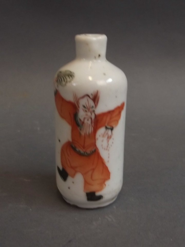 A late C19th Chinese porcelain scent bottle decorated: A late C19th Chinese porcelain scent bottle decorated with a gentleman in red robes and a bat, 3" high