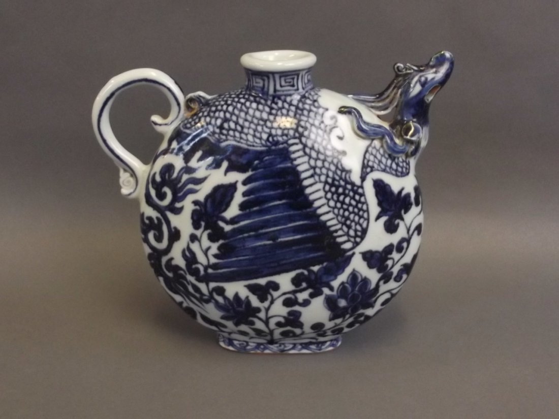A Chinese Yuan style blue and white porcelain ewer with: A Chinese Yuan style blue and white porcelain ewer with phoenix head shaped spout, 7" high