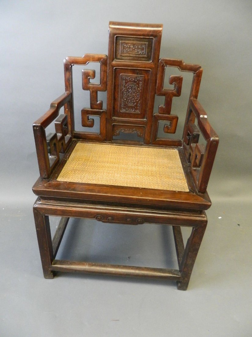 A Chinese hardwood throne chair with carved back panels: A Chinese hardwood throne chair with carved back panels and scroll arms, 23" x 37", seat 18" high