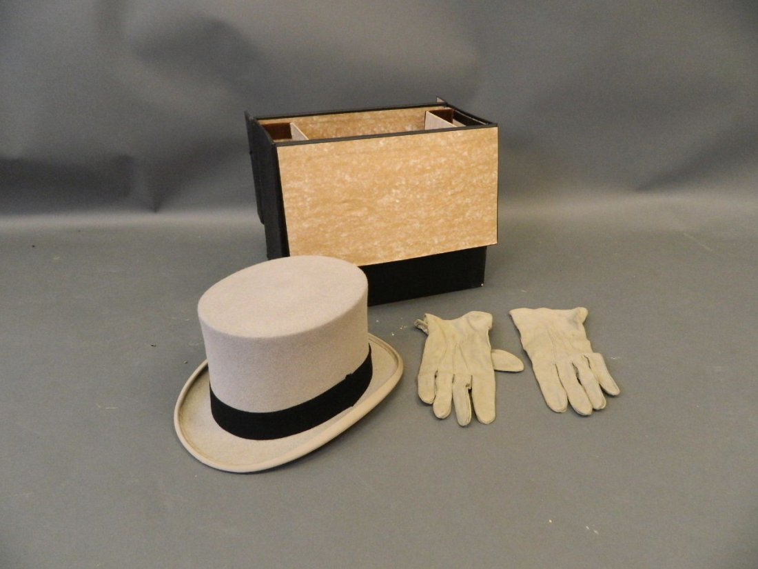 A gentleman's grey top hat and fitted hat box by: A gentleman's grey top hat and fitted hat box by 'Woodrow & Sons, Piccadilly, London', together with a pair of matching gloves, hat size 7