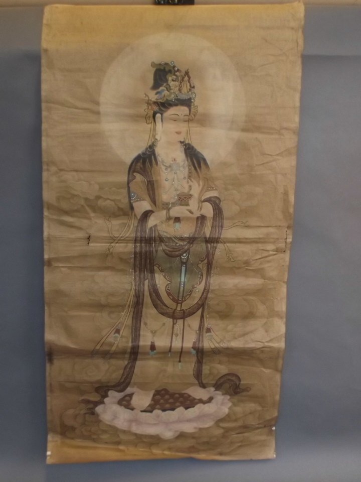 A Chinese printed scroll decorated with Quan Yin: A Chinese printed scroll decorated with Quan Yin standing on a lotus flower, 20" x 38"