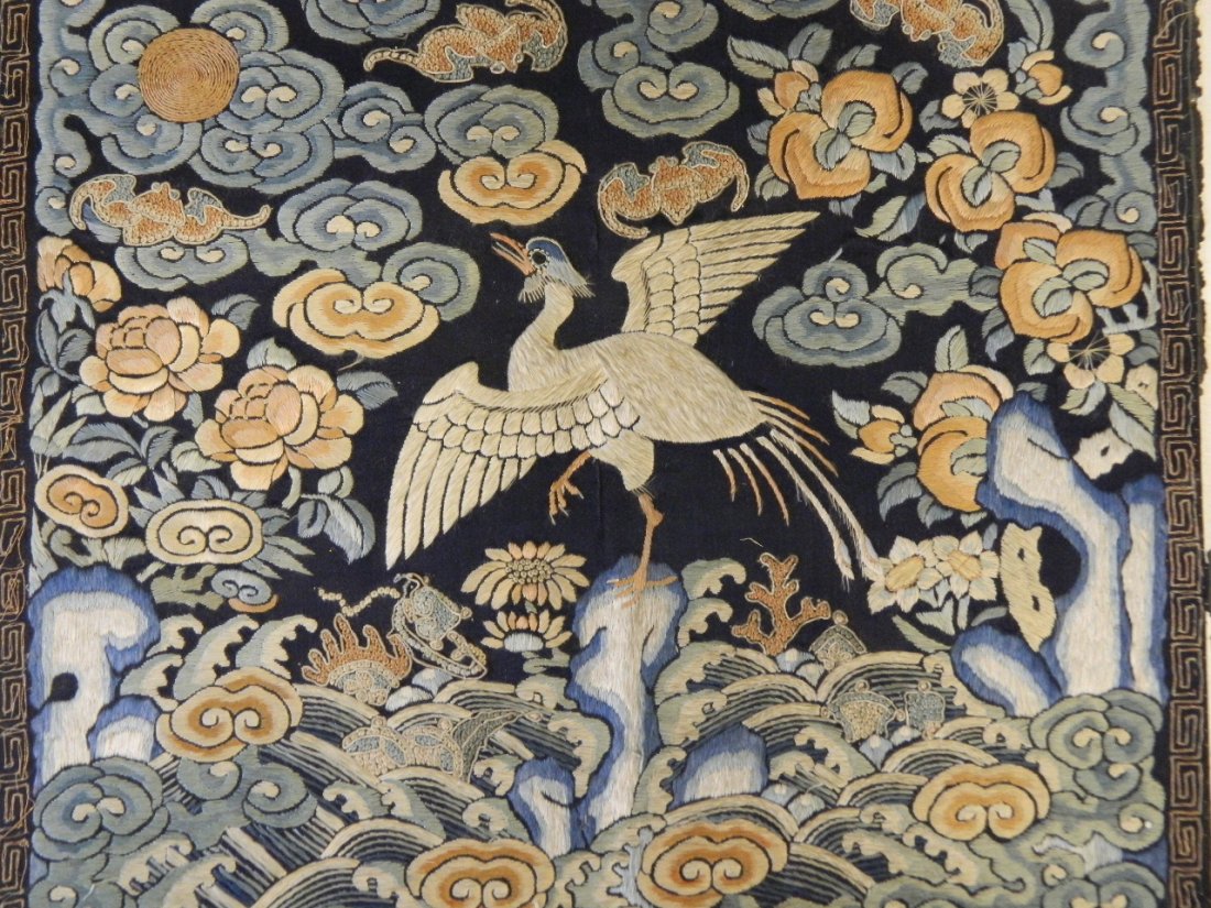 A Chinese silk embroidered rank badge with phoenix and: A Chinese silk embroidered rank badge with phoenix and five bat decoration, 12" square