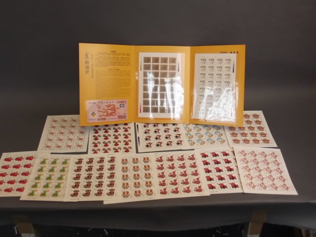 A Chinese millennium commemorative wallet containing: A Chinese millennium commemorative wallet containing stamps and a bank note, with a loose collection of Chinese contemporary stamp sheets, wallet 8" x 11"