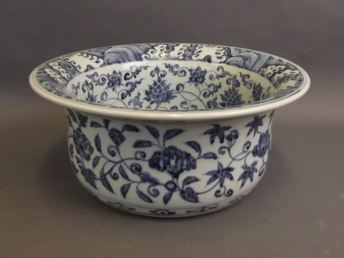 A Chinese Ming style blue and white jardinière with: A Chinese Ming style blue and white jardinière with scrolling lotus decoration, 13" diameter