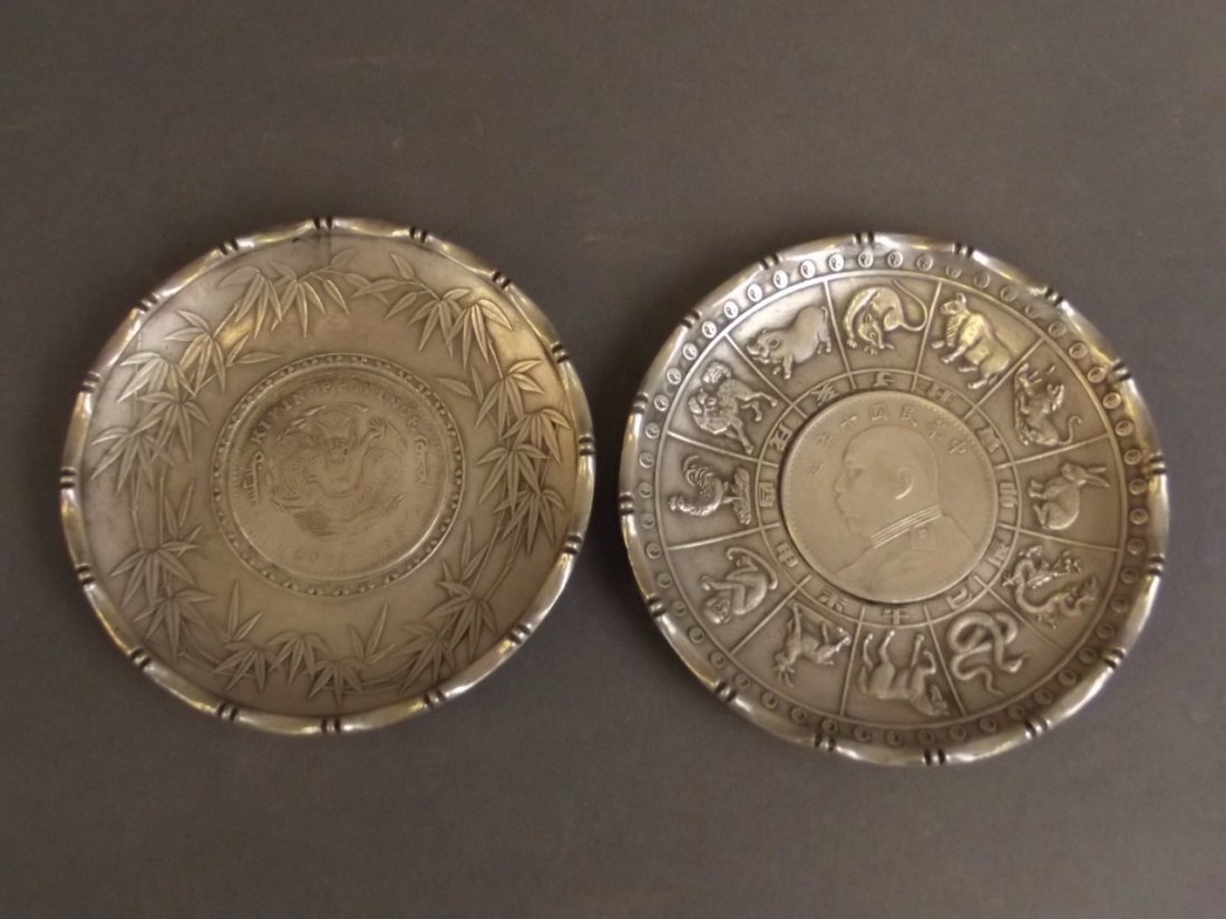 A Chinese white metal coin dish decorated with zodiac: A Chinese white metal coin dish decorated with zodiac animals, and another similar, 4" diameter
