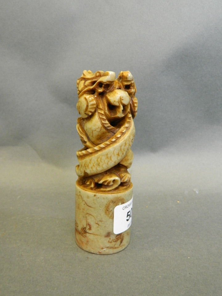 A Chinese soapstone seal, the handle carved as two: A Chinese soapstone seal, the handle carved as two dragons with a pearl, 5" high