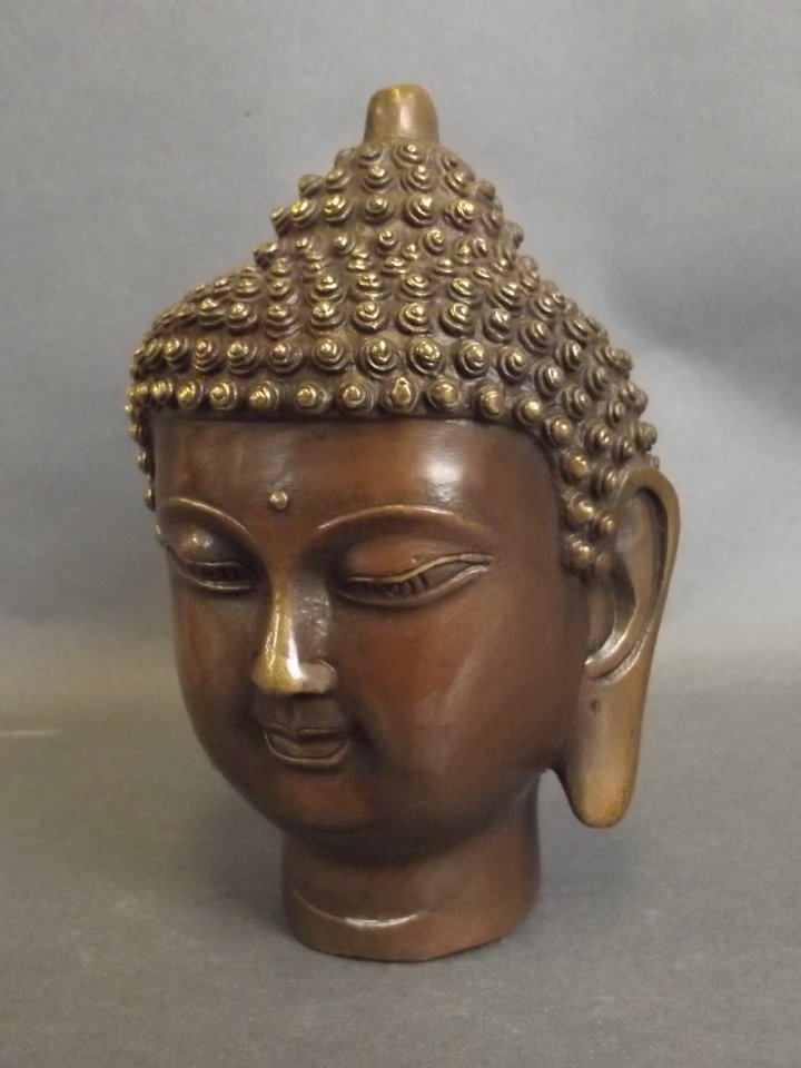 A bronze figure of Buddha's head, seal mark to base, 6": A bronze figure of Buddha's head, seal mark to base, 6" high