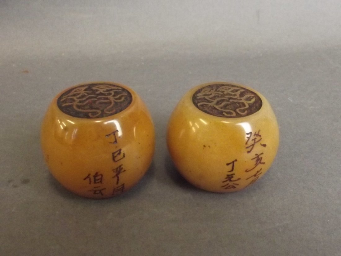 A pair of Chinese circular seals decorated with: A pair of Chinese circular seals decorated with calligraphy, 1"