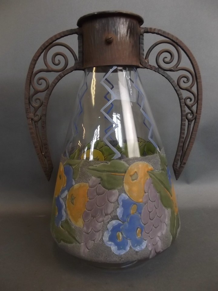 A 1930s French Art glass vase with enamelled floral and: A 1930s French Art glass vase with enamelled floral and fruit decoration and cast iron handle, mount by Albert Mazoyer, signed to the body, 11" high