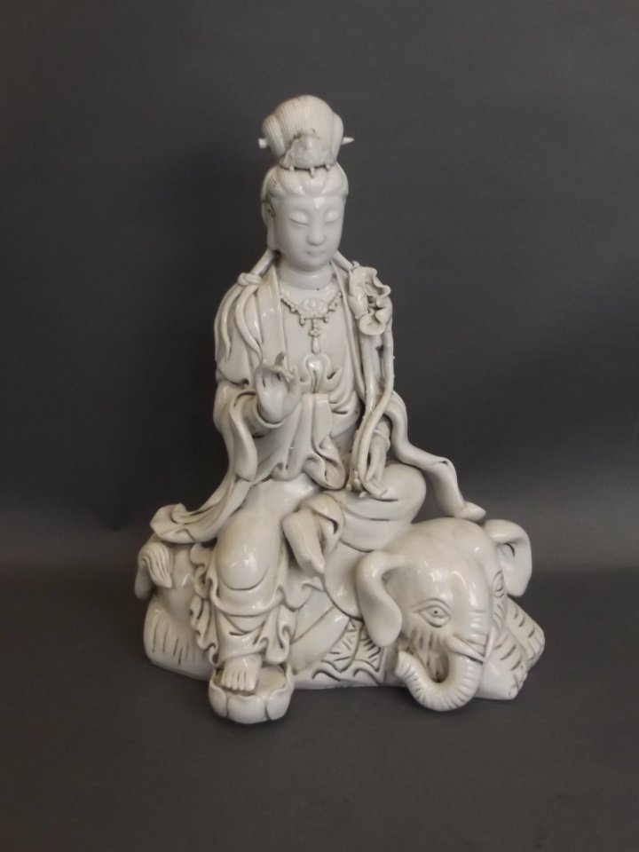 A large Chinese blanc de chine figure of Quan Yin: A large Chinese blanc de chine figure of Quan Yin sitting on an elephant, impressed mark verso, 12" high