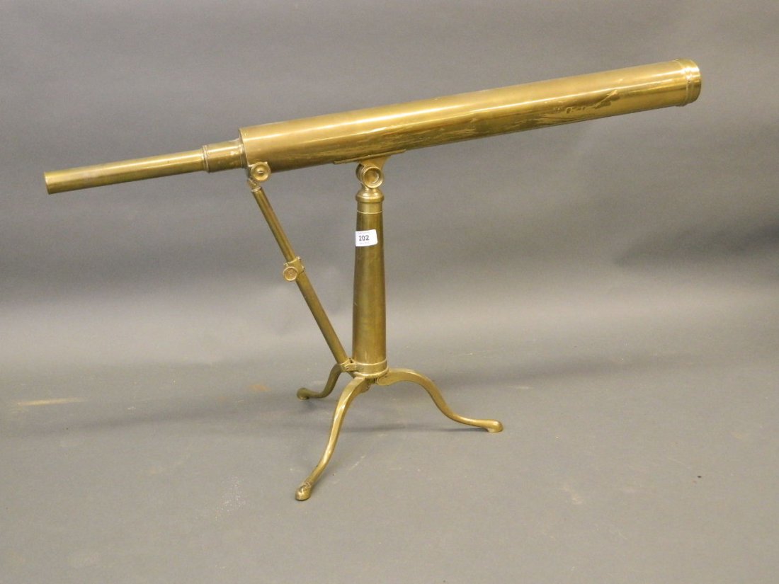 A brass telescope on a swivelling stand and fold up (1 of 2)