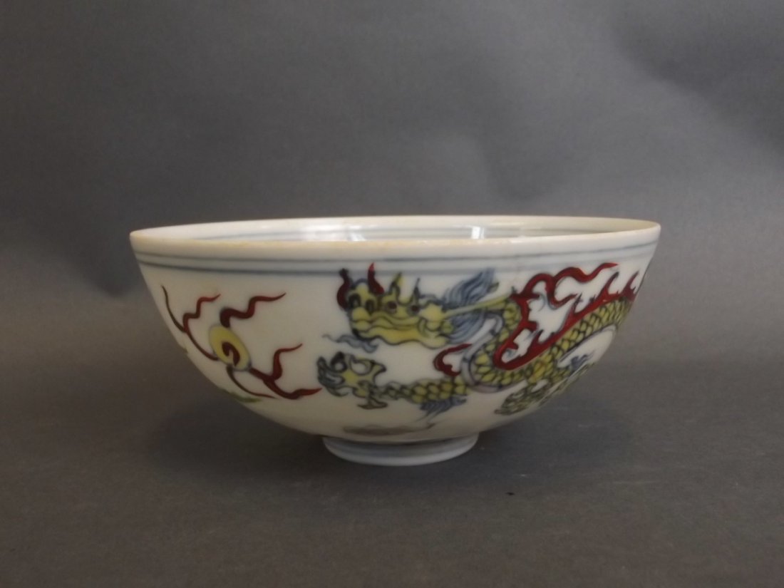 A Chinese Doucai enamel eggshell porcelain rice bowl: A Chinese Doucai enamel eggshell porcelain rice bowl with painted dragon and phoenix decoration, 6 character mark to base, 4" diameter