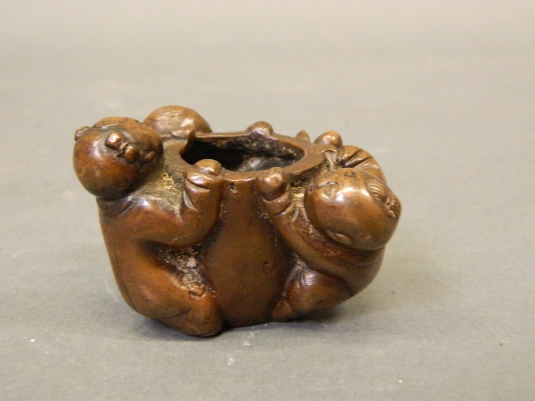 A small Chinese bronze censer decorated with three boys (1 of 5)
