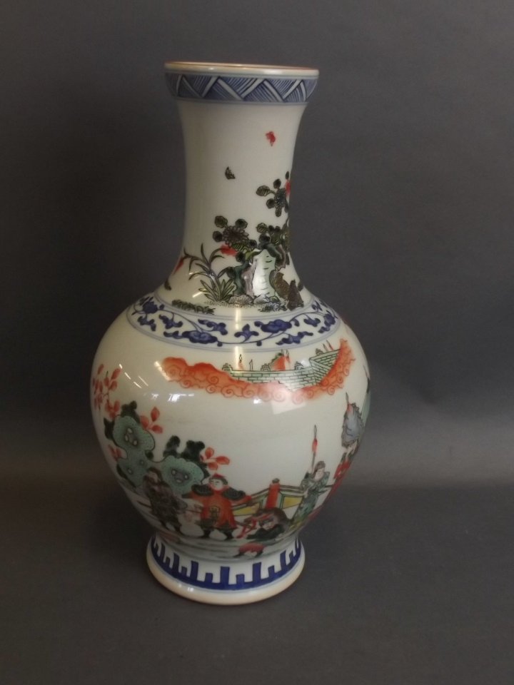 A Chinese enamelled porcelain vase decorated with: A Chinese enamelled porcelain vase decorated with warriors sparring, 6 character mark to base, 11" high