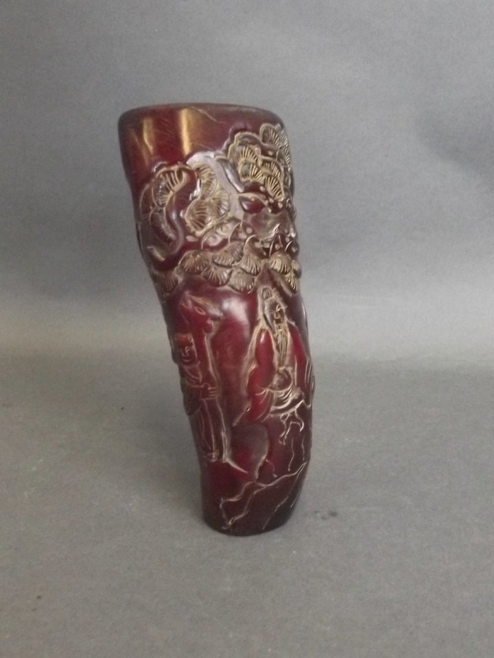 A Chinese carved horn libation cup decorated with a (1 of 3)
