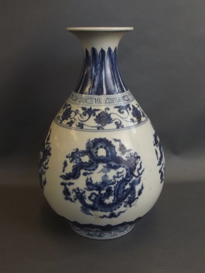 A Chinese blue and white porcelain pear shaped vase: A Chinese blue and white porcelain pear shaped vase with lotus flower and dragon decoration, 6 character mark to side, 13" high (AF repair to rim)