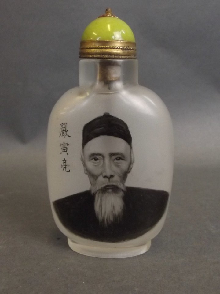 A Peking glass snuff bottle with reverse painted: A Peking glass snuff bottle with reverse painted decoration of a Chinese gentleman, inscription verso, 3" high