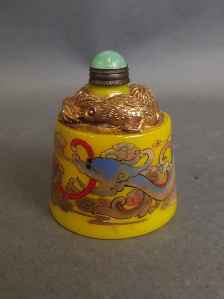 A Peking glass snuff bottle with gilt highlights and: A Peking glass snuff bottle with gilt highlights and enamelled dragon decoration, 2" high