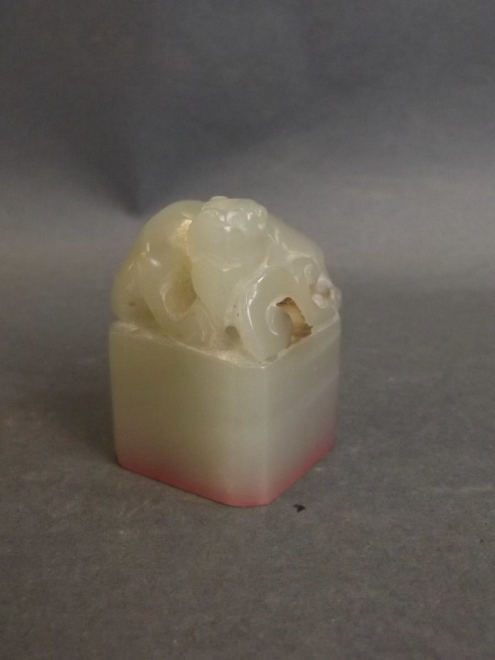 A Chinese celadon jade seal with carved and pierced (1 of 3)