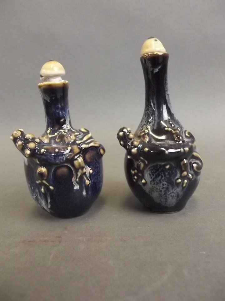A Chinese porcelain snuff bottle with applied dragon: A Chinese porcelain snuff bottle with applied dragon decoration on a mottled blue ground, and another similar, 3" high