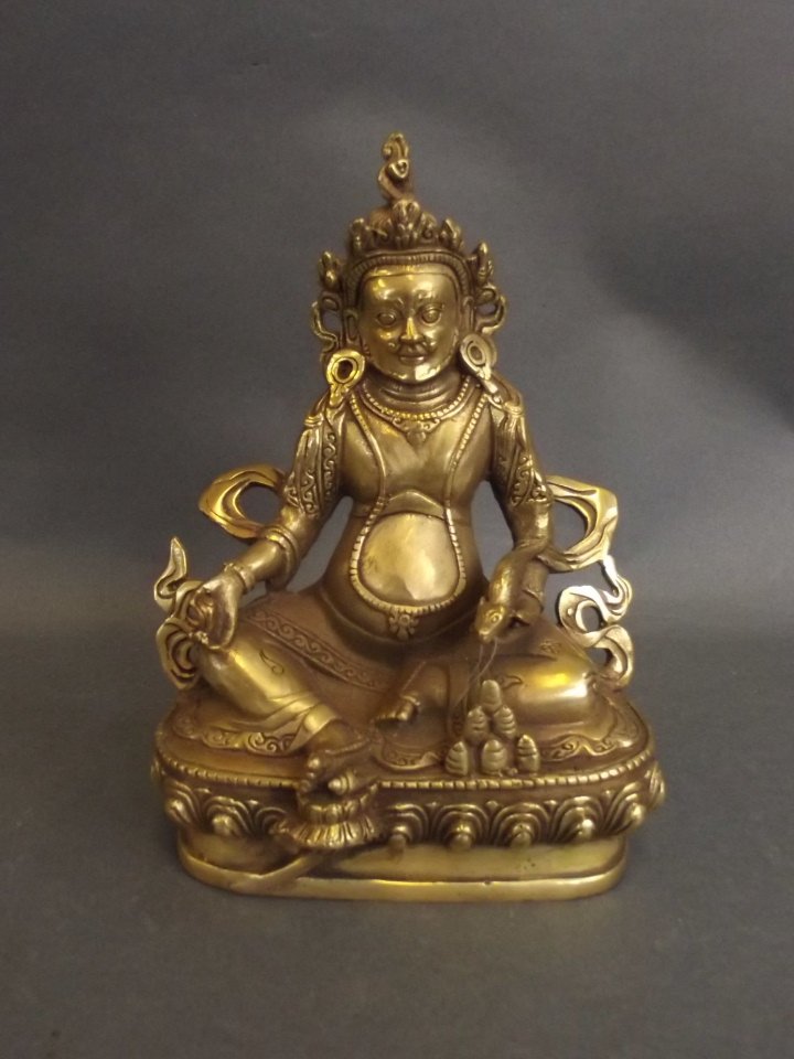 A Sino-Tibetan gilt brass figure of a seated deity (1 of 2)