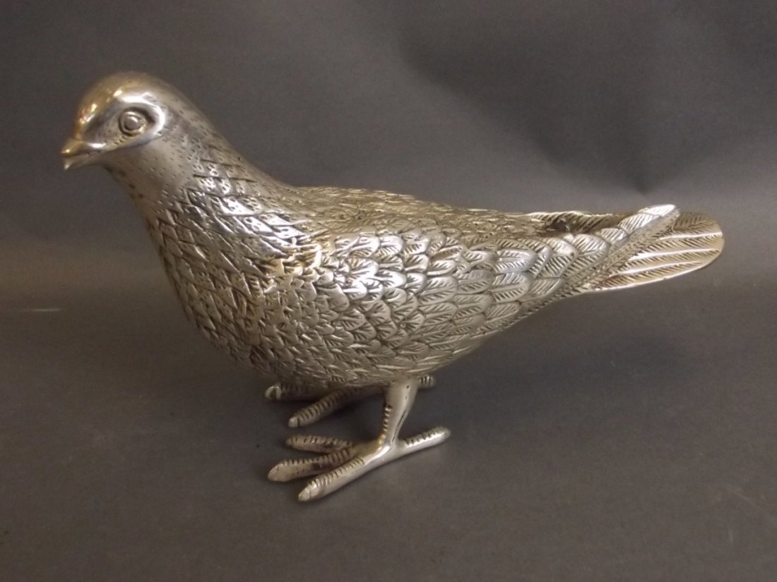 A white metal figure of a dove, 8" long: A white metal figure of a dove, 8" long