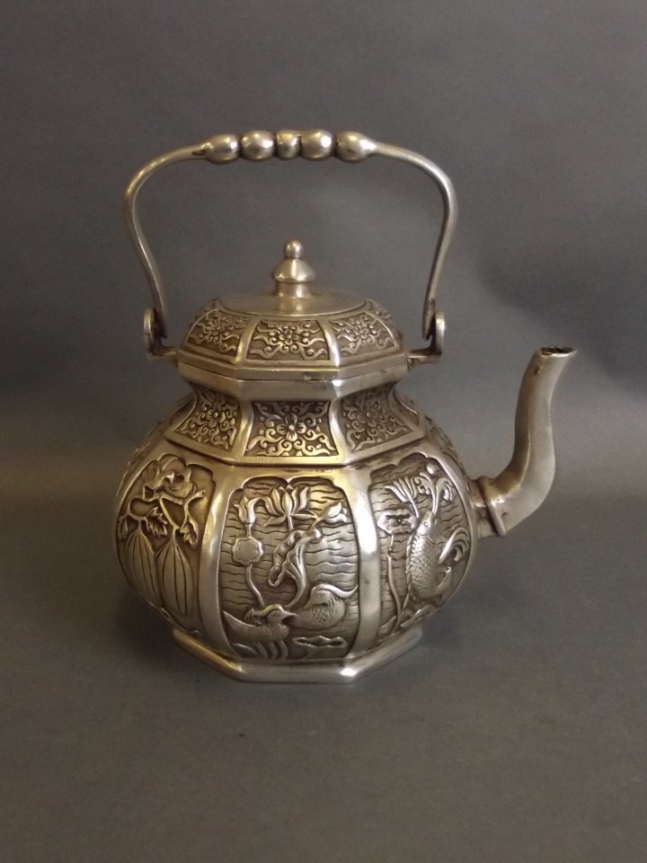 A Chinese white metal teapot with decorative panels (1 of 2)