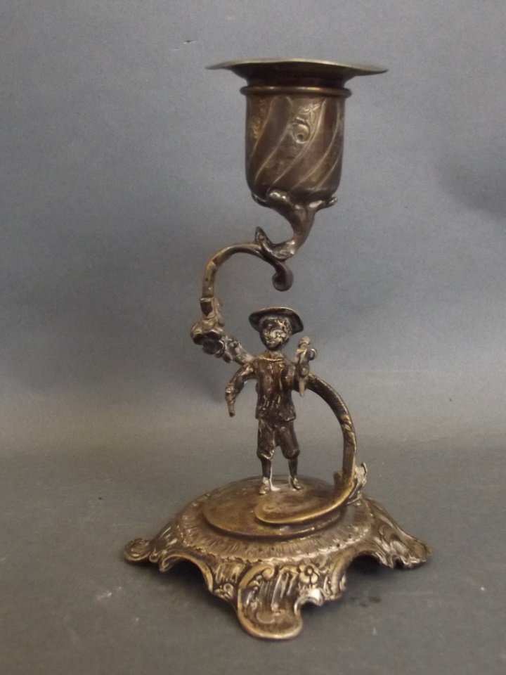 A Continental silver candlestick, the base decorated (1 of 2)
