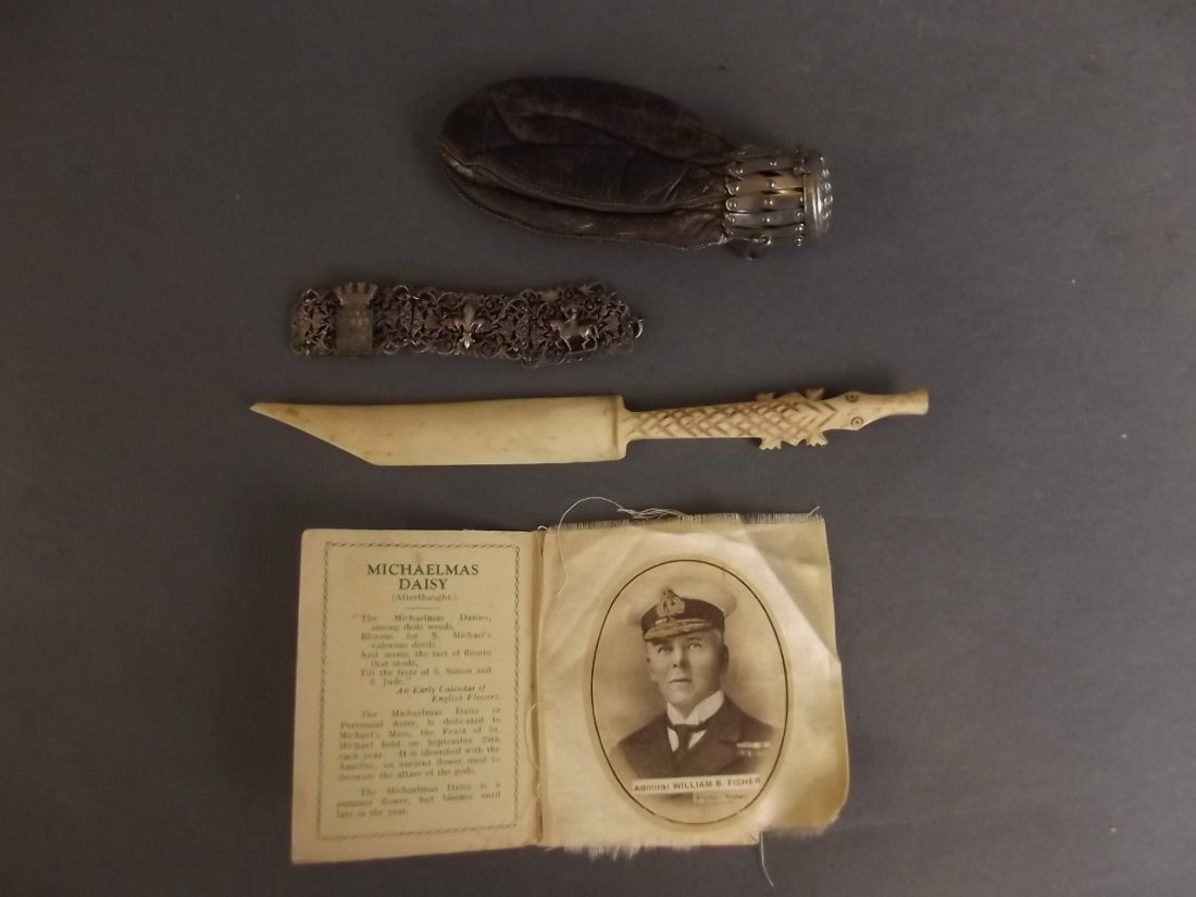 A Victorian leather pouch purse, a French silver: A Victorian leather pouch purse, a French silver bracelet, a carved bone paper knife, and two silk cards, purse 4" long