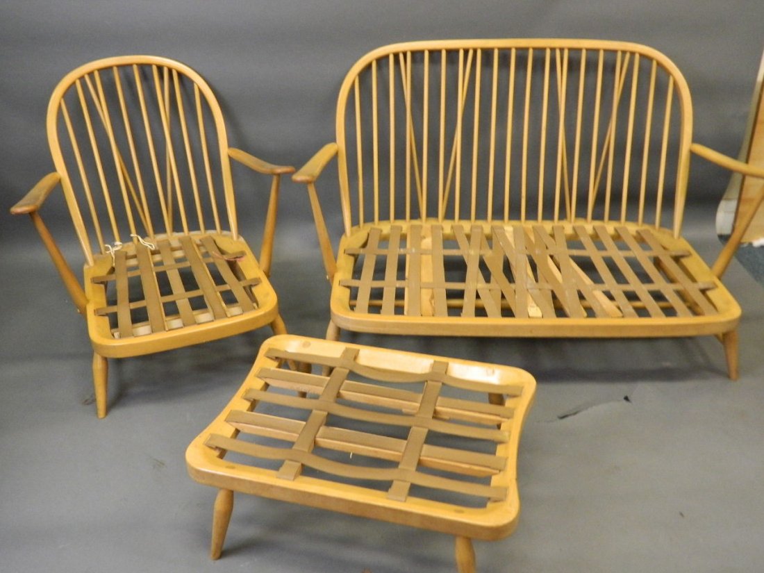 An Ercol two seated stick back settee with matching: An Ercol two seated stick back settee with matching armchair and stool, settee 52" wide, seat 14" high, back 33" high