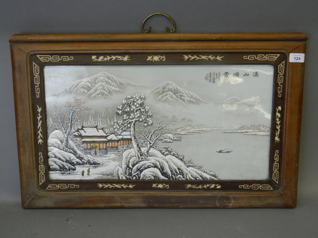 A Chinese enamelled porcelain panel decorated with a: A Chinese enamelled porcelain panel decorated with a riverside pagoda in a snowy landscape, mounted in a hardwood frame, 28" x 17"
