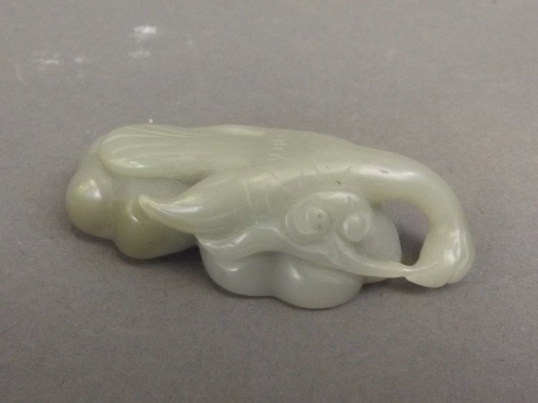 A Chinese celadon jade pendant with carved stork and (1 of 2)