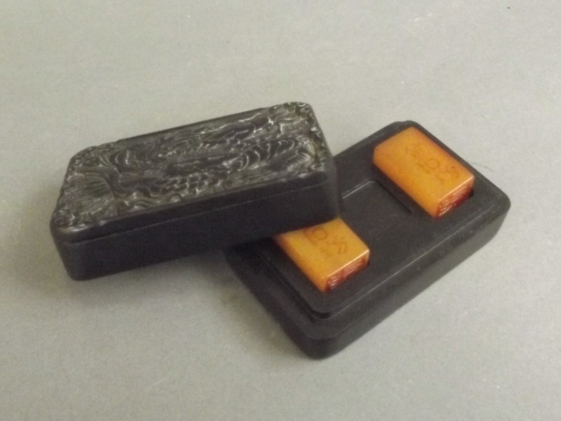 A pair of Chinese amber soapstone seals in a black (1 of 4)