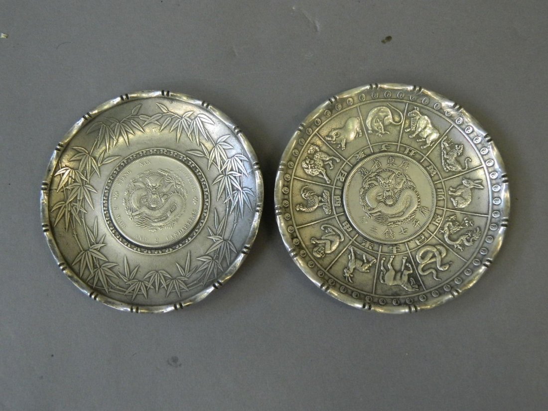 A Chinese silvered metal coin dish with bamboo: A Chinese silvered metal coin dish with bamboo decoration, and another similar, 4" diameter
