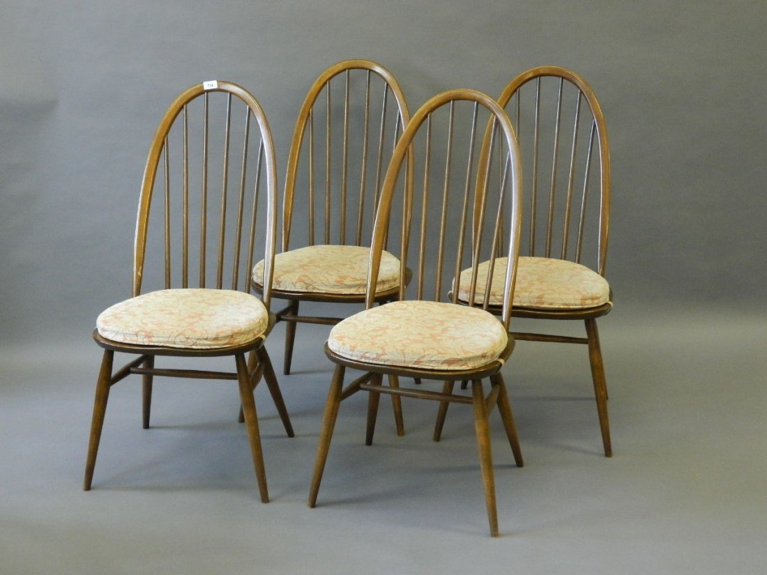 A set of four stained beech Ercol hoop backed chairs: A set of four stained beech Ercol hoop backed chairs