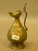 An antique Middle Eastern brass and copper inlaid wine