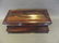 A Regency bombé shaped rosewood twin compartment tea