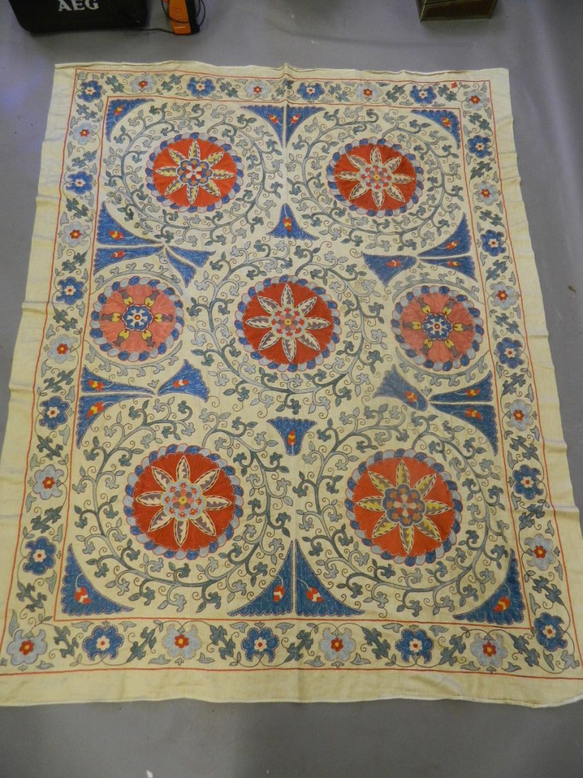 An early C20th Ottoman embroidered silk throw with: An early C20th Ottoman embroidered silk throw with stylised floral decoration, 61½" x 77"