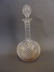 A lead crystal decanter with a cross-cut body, facet